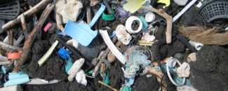 Virtually indestructible pieces of plastic fouling a black rock beach on the island of Hawaii. Virtually indestructible pieces of plastic fouling a black rock beach on the island of Hawaii.
